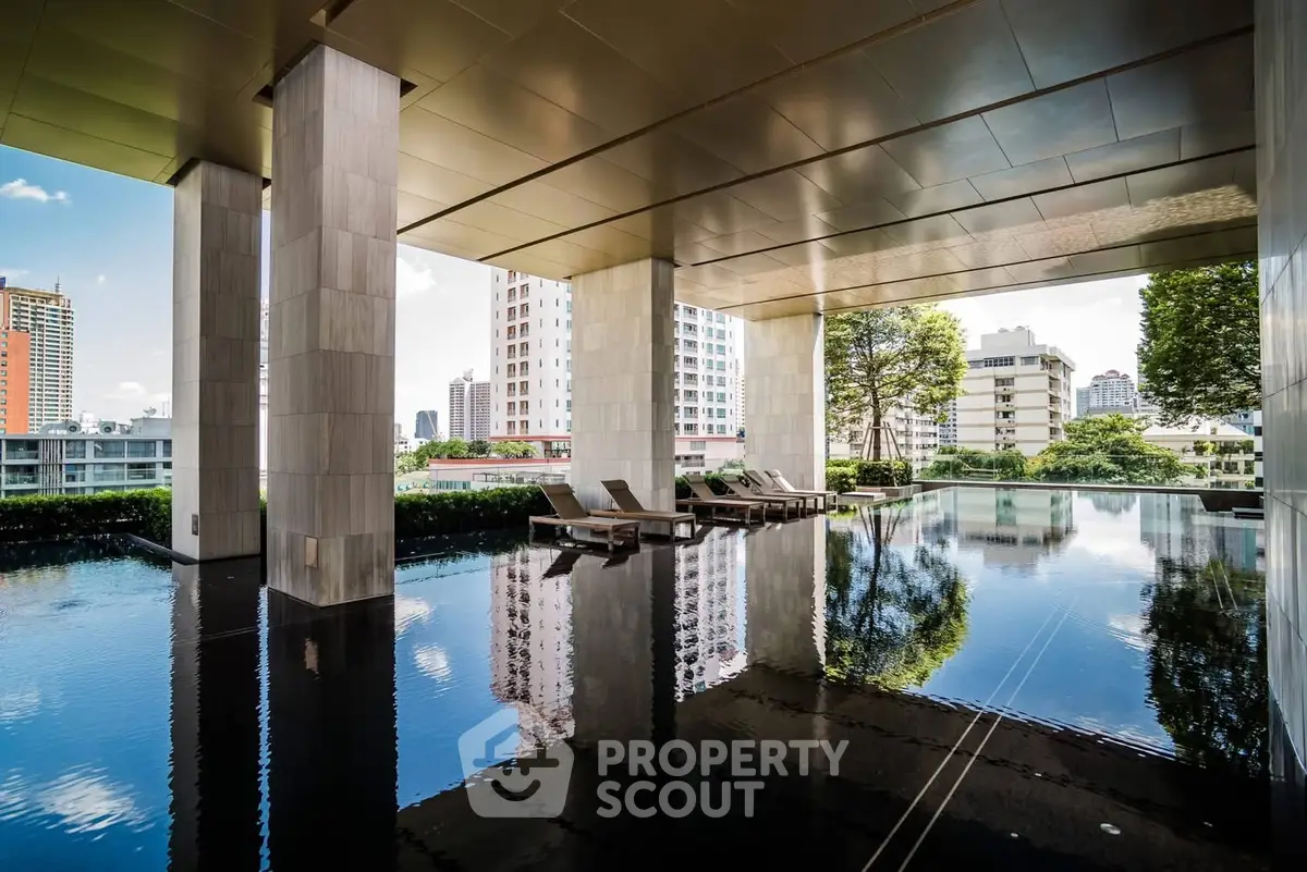 Luxurious rooftop pool with city skyline views and elegant lounge chairs.