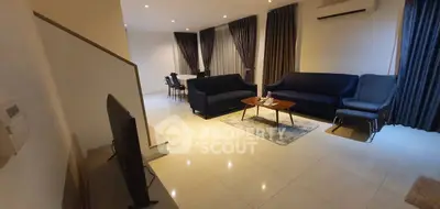 Spacious modern living room with elegant furniture and dining area