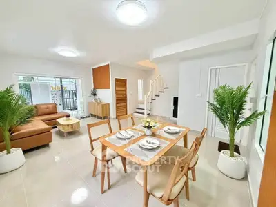Spacious modern living and dining area with elegant decor and natural light.