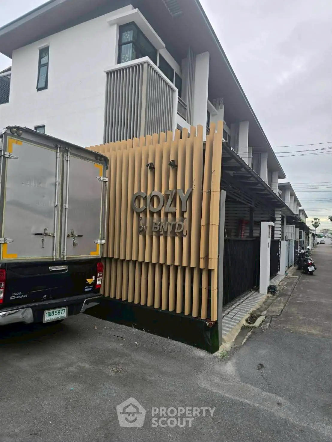 Modern townhouse exterior with sleek design and cozy ambiance in urban setting.