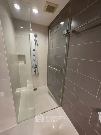 Modern bathroom with glass shower enclosure and sleek tile design