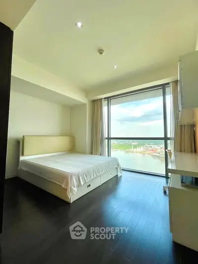 Spacious bedroom with stunning city view and large window