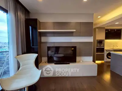 Modern living room with sleek TV unit and open kitchen design