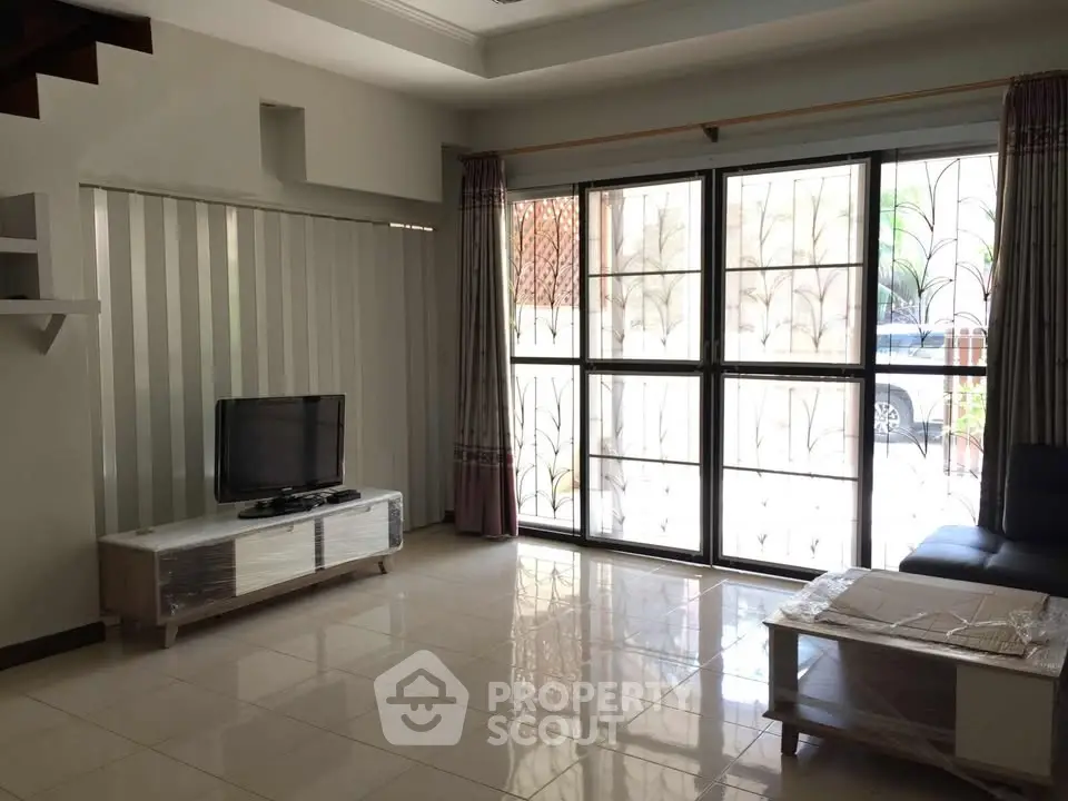 Spacious living room with large windows and modern furniture