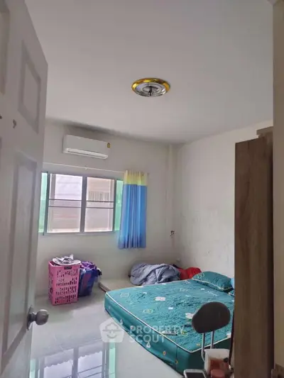 Cozy bedroom with air conditioning and minimalist decor, perfect for a comfortable living space.