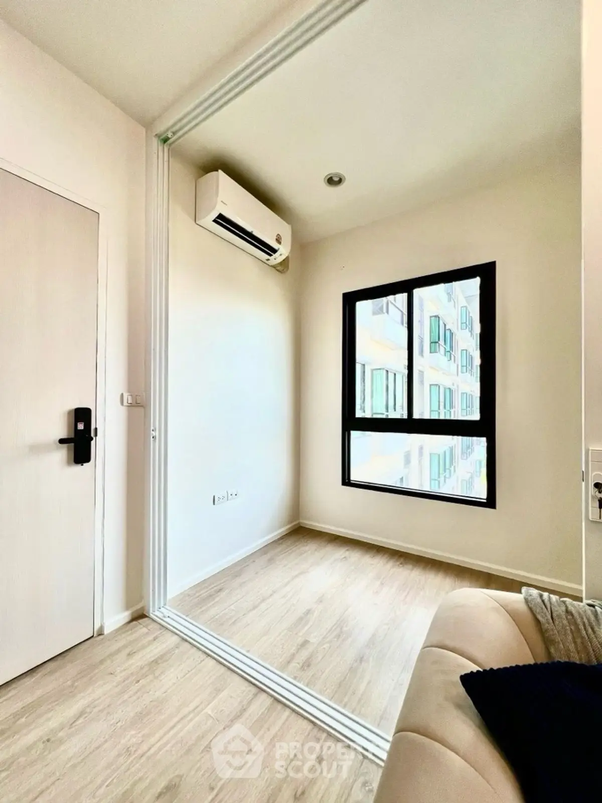 Modern minimalist room with large window and air conditioning, perfect for a cozy living space.