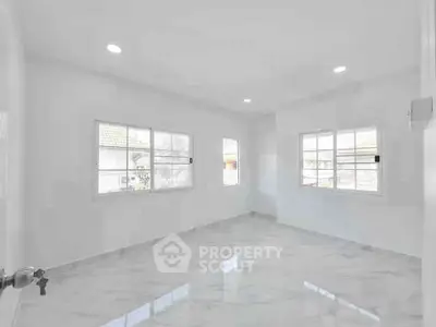 Spacious and bright empty room with large windows and marble flooring, perfect for customization.