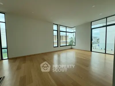 Spacious corner unit with large windows and wooden flooring, offering abundant natural light and modern design.
