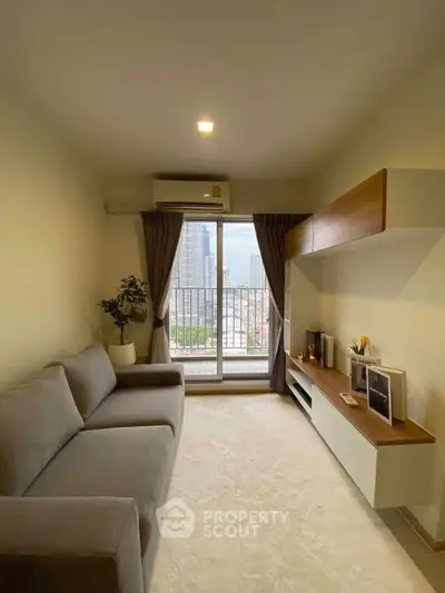 Modern living room with city view, featuring sleek furniture and natural light.