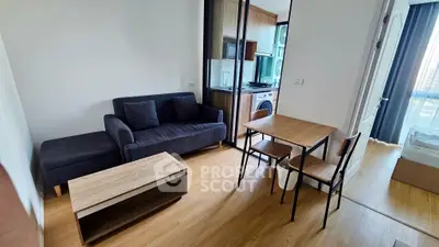 Modern apartment interior with cozy living room and compact kitchen area.