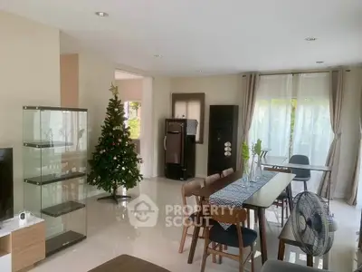 Spacious living room with modern decor and Christmas tree, perfect for holiday gatherings.