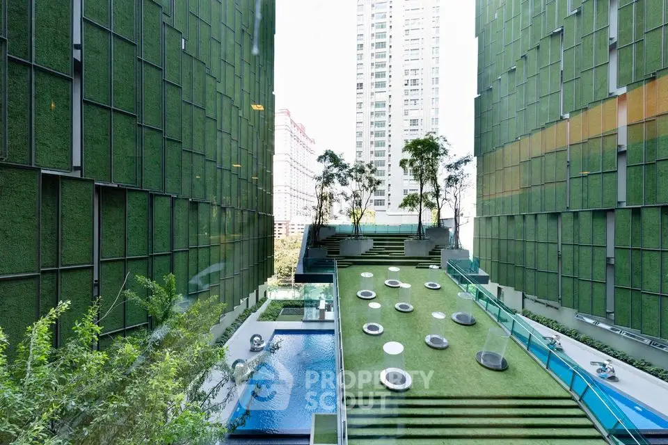 Luxurious urban garden with pool and modern architecture in high-rise complex