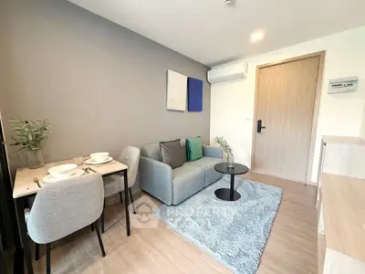 Modern living room with cozy seating and dining area, featuring stylish decor and natural light.