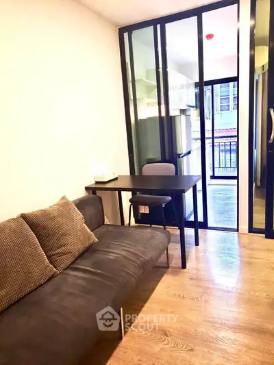 Modern living room with glass partition and cozy seating area