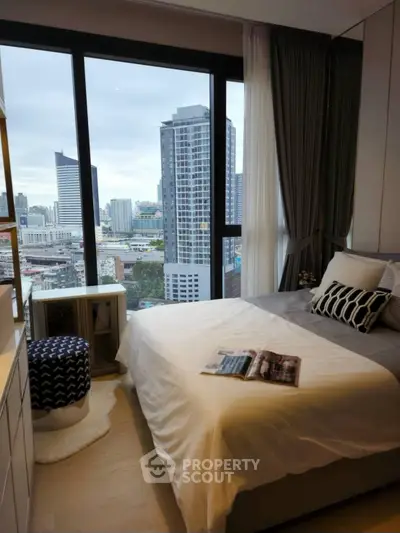 Modern bedroom with stunning city view from large window, featuring stylish decor and cozy ambiance.