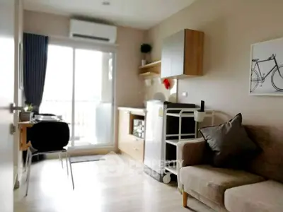 Modern living room with cozy sofa, stylish decor, and balcony access in a contemporary apartment.