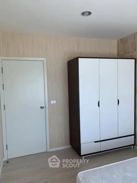 Modern bedroom with sleek wardrobe and neutral tones