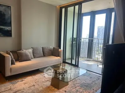Modern living room with glass coffee table and balcony view in high-rise apartment.