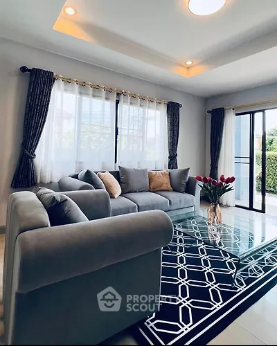 Elegant living room with modern gray sofa and stylish glass coffee table