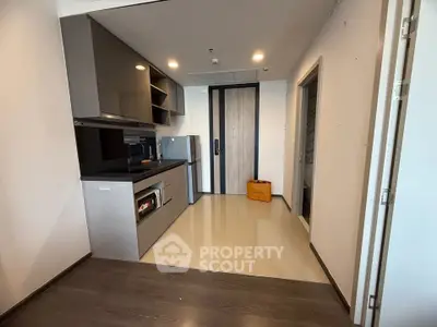 Modern kitchen with sleek appliances and stylish cabinetry in a contemporary apartment.