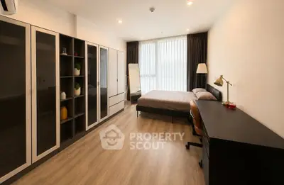 Spacious modern bedroom with large wardrobe and natural light