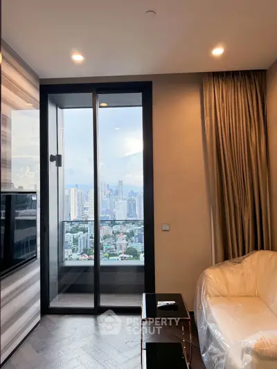 Modern living room with city view and balcony access in high-rise apartment