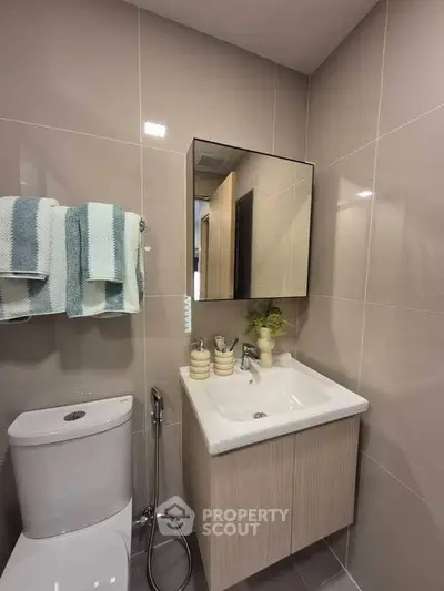 Modern bathroom with sleek fixtures and stylish vanity in a contemporary home.