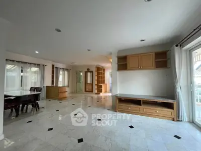 Spacious open-plan living area with elegant marble flooring and ample natural light.
