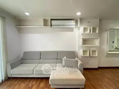 Modern living room with sleek gray sofa and stylish wall shelves, perfect for contemporary living.
