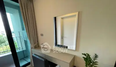 Modern bedroom with balcony access and sleek vanity setup