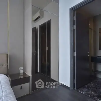 Modern bedroom with mirrored wardrobe and sleek design