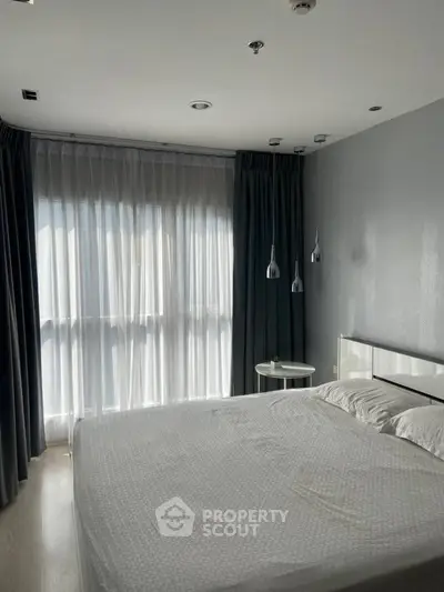 Modern bedroom with large window and stylish lighting