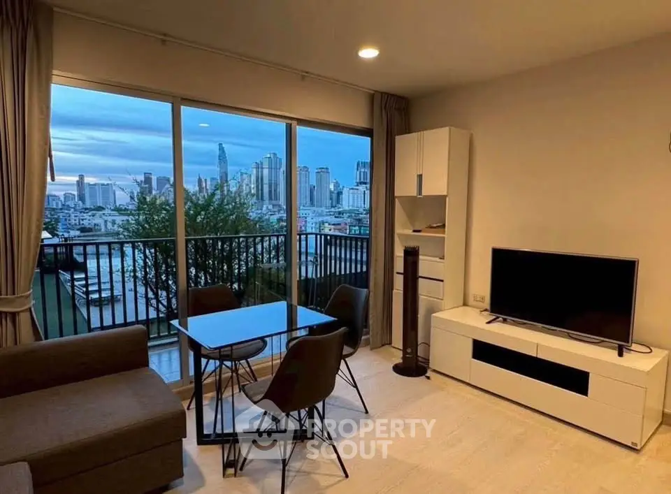 Modern living room with city view, featuring stylish furniture and large windows for natural light.