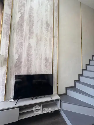 Modern interior with stylish staircase and TV unit in a contemporary home