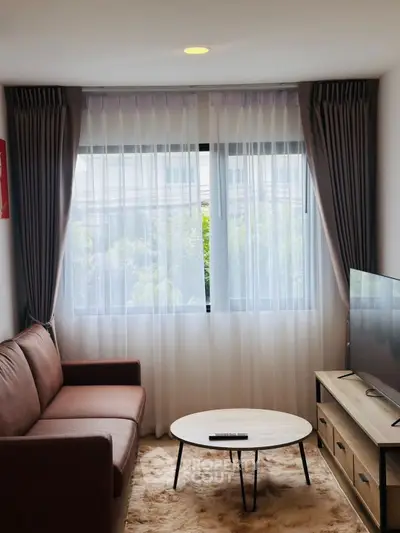 Cozy living room with modern decor and large window view