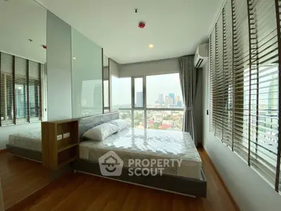 Spacious bedroom with city view in modern high-rise apartment
