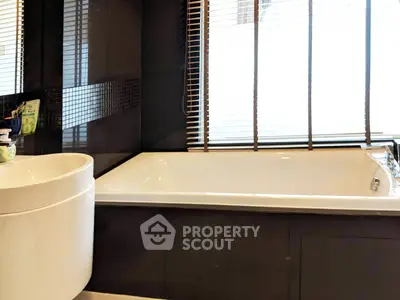 Modern bathroom with sleek bathtub and stylish blinds