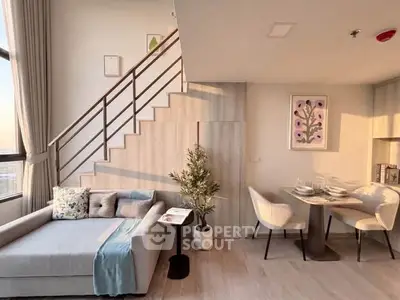 Modern duplex living room with stylish decor and dining area, featuring large windows and elegant staircase.