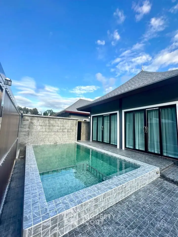 Luxurious villa with private pool and modern architecture under clear blue sky.