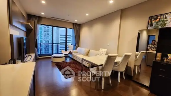 Spacious modern living room with elegant dining area and city view balcony.