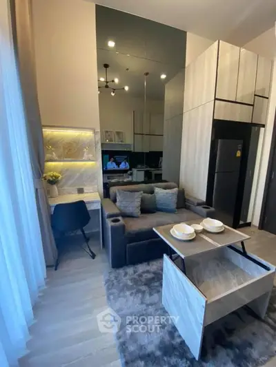 Modern living room with stylish decor, cozy sofa, and elegant dining setup in a chic apartment.