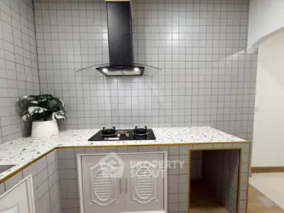 Modern kitchen with sleek gas stove and stylish backsplash tiles