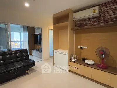 Modern living room with sleek black sofa and built-in entertainment unit