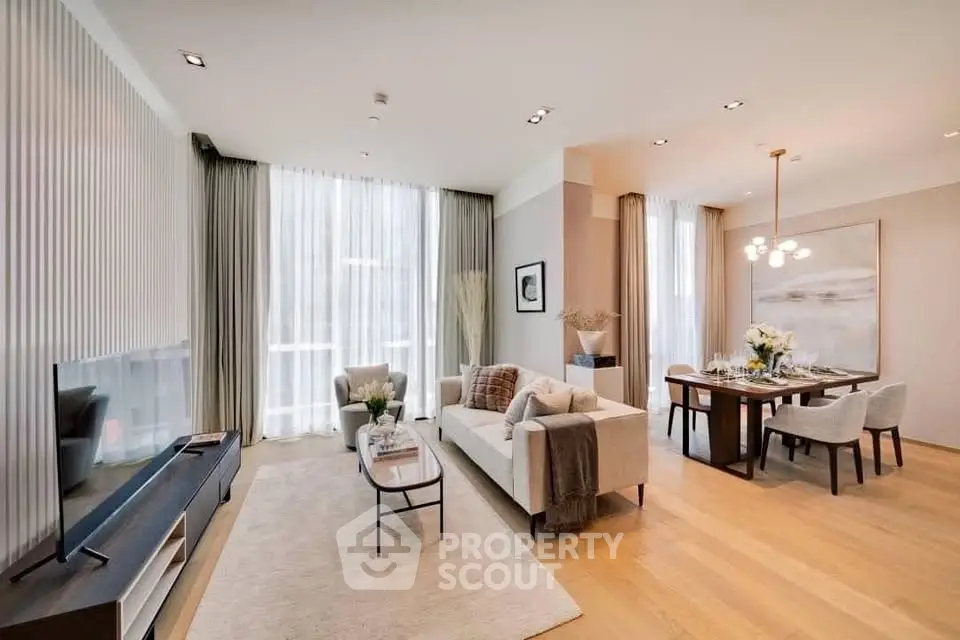 Spacious modern living room with elegant dining area and large windows in luxury apartment.