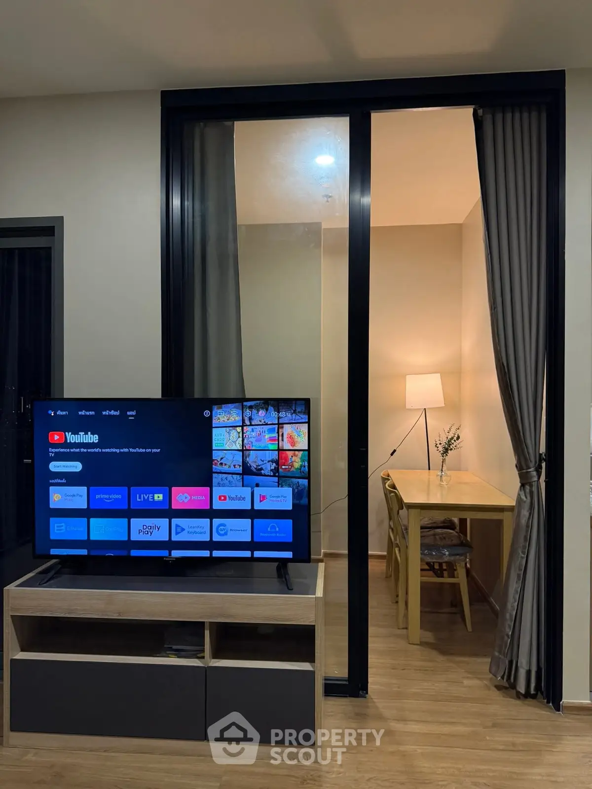Modern living room with TV and cozy study area, perfect for relaxation and productivity.