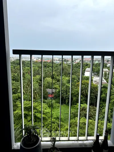 Stunning balcony view overlooking lush greenery and cityscape, perfect for relaxation and enjoying nature.