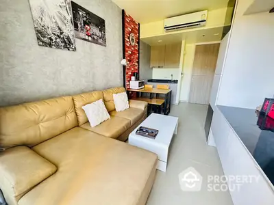 Chic modern living room seamlessly connected to a stylish kitchen area, featuring a comfortable beige sofa, sleek white coffee table, and a vibrant red accent wall.