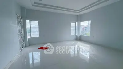 Spacious empty room with large windows and glossy tiled floor