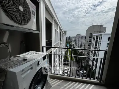Modern apartment balcony with washing machine and city view
