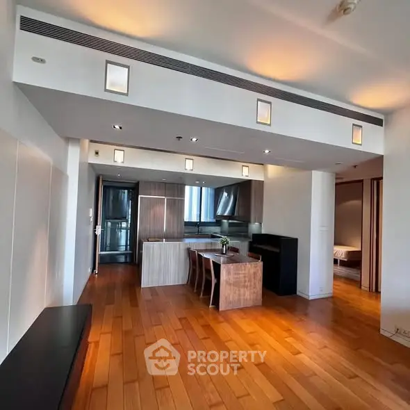 Spacious modern kitchen with wooden flooring and sleek design